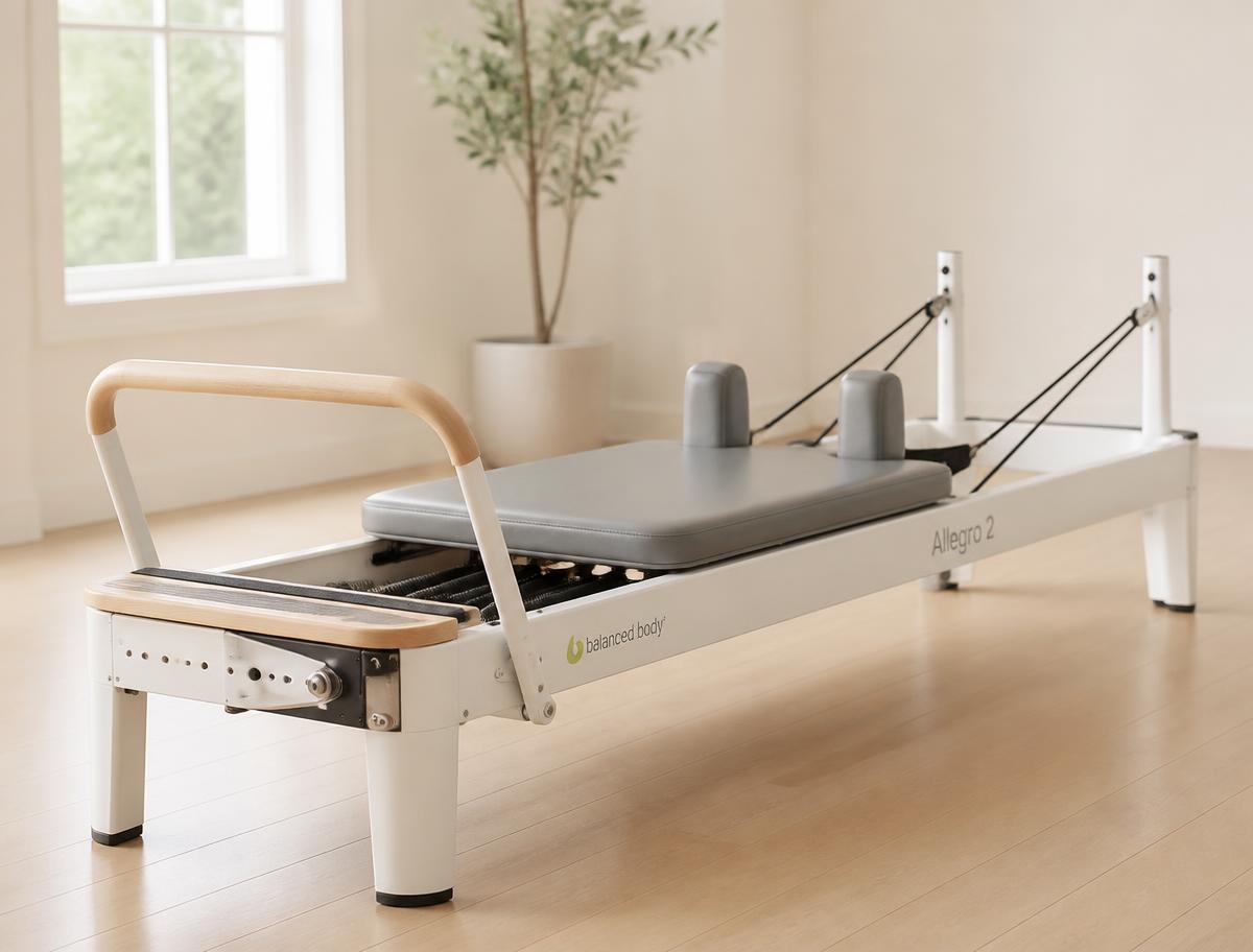 White and wood Balanced Body Allegro 2 reformer in a bright studio